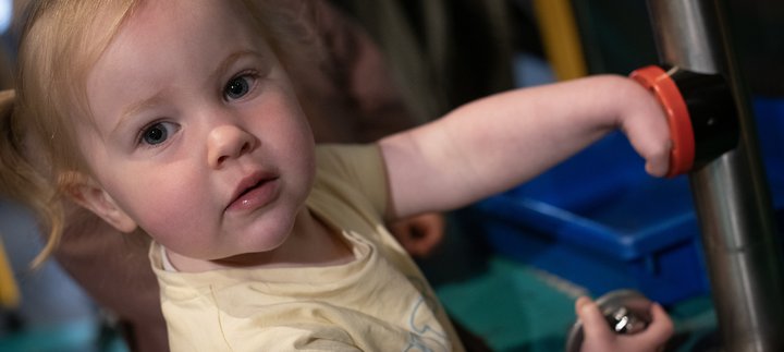 little girl plays in gallery