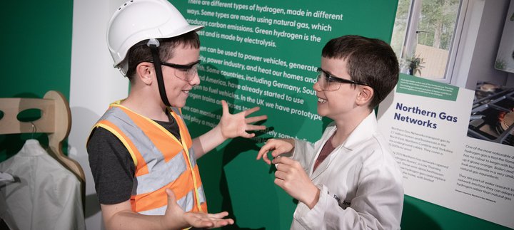 two boys smile and chat in the Steam to Green space