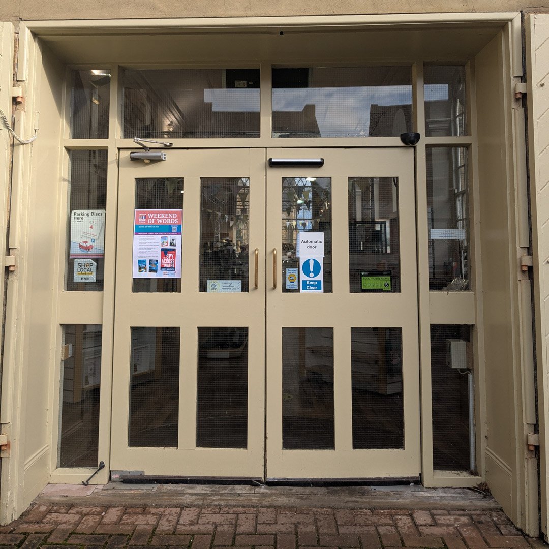 A set of beige automatic double doors.