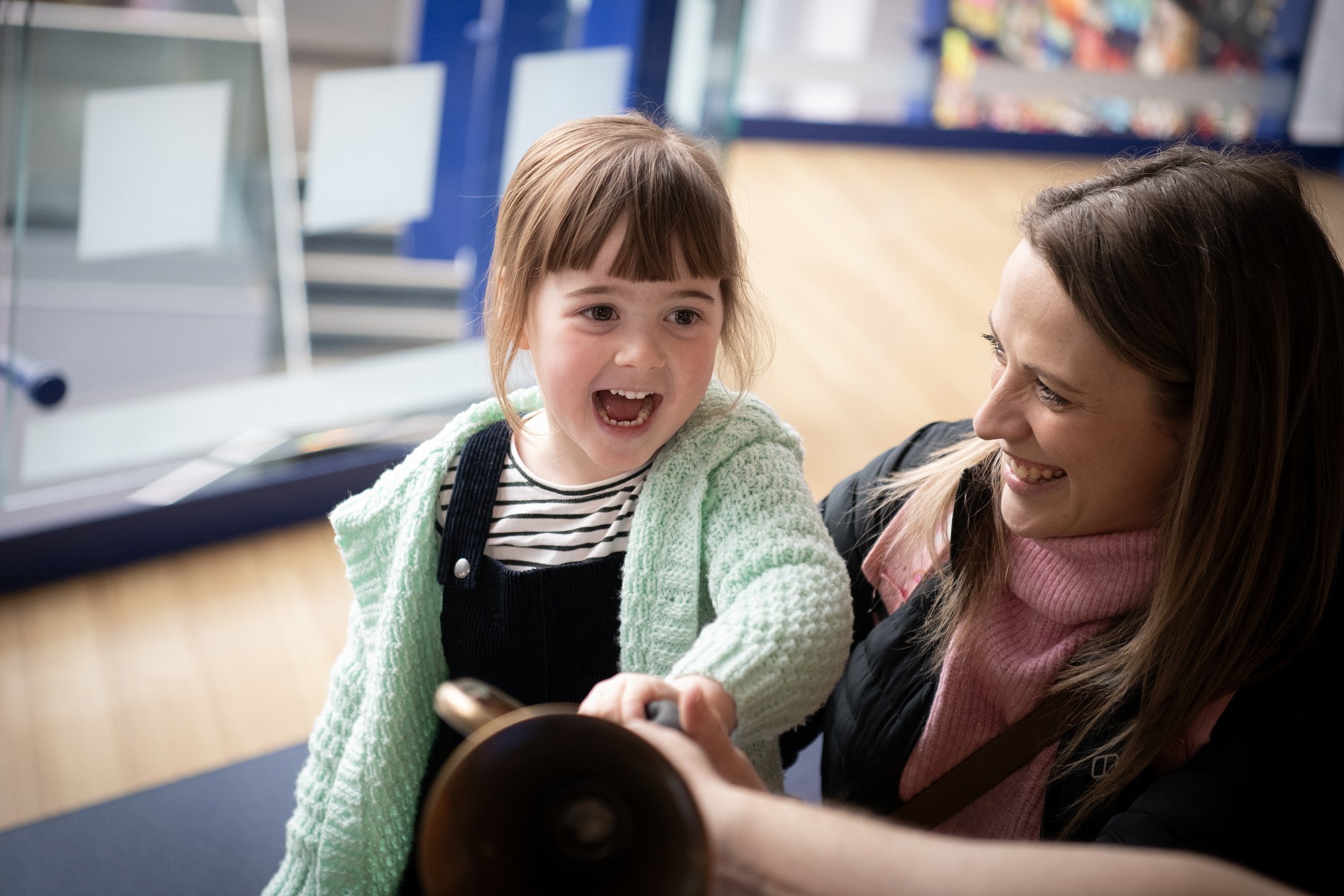 A woman and toddler laughing together A woman and toddler laughing together