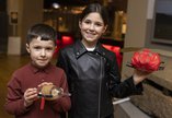 Two children holding crafty creatures