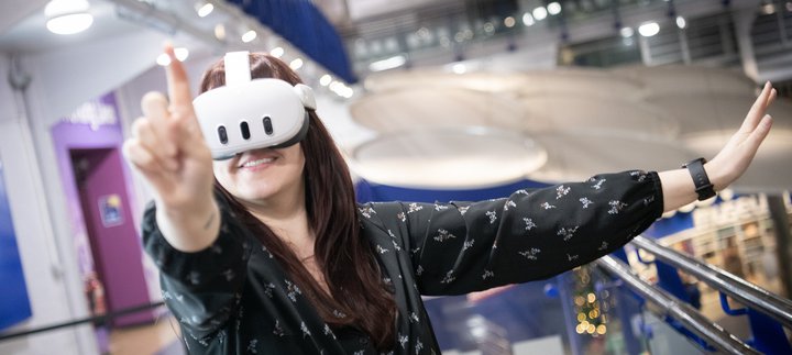 woman with long dark hair wears VR headset