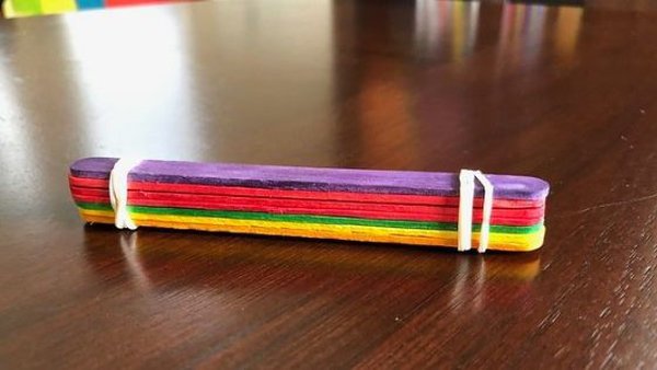Stack of coloured lolly sticks tied together at both ends