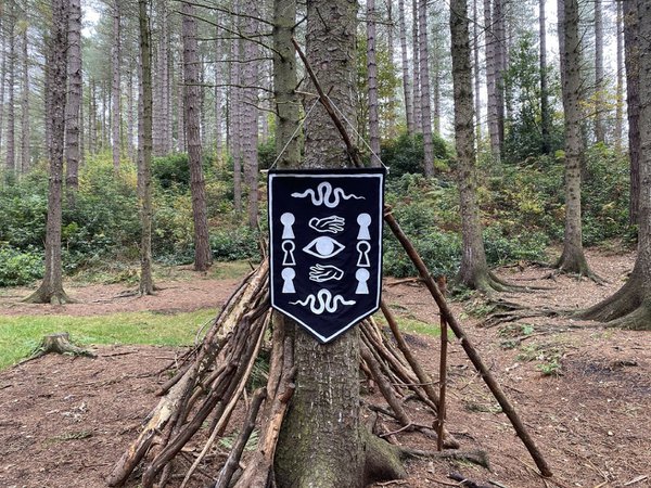 A banner with symbols hang from a tree