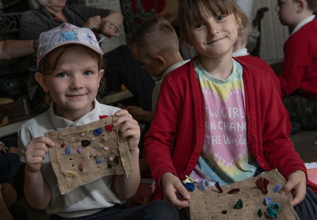 Children holding up their proggy crafts 