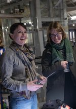 three people smiling in the museum at night