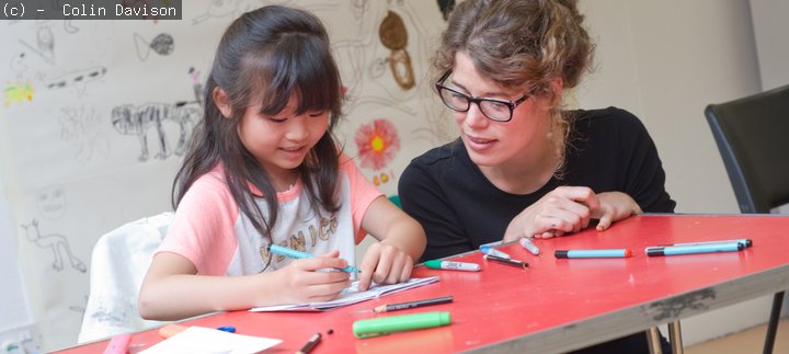 Young girl talking to an art educator