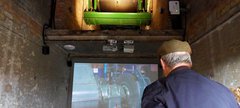 Man with hat looking at screen 