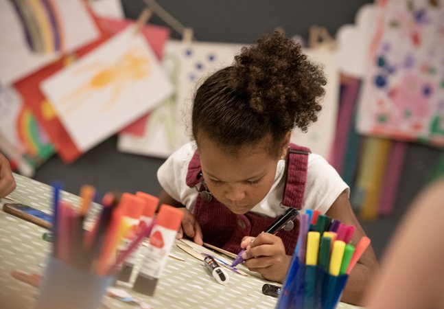 girl concentrates making a glider 