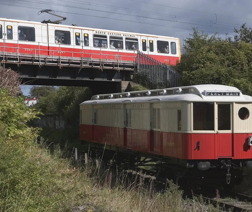 Original 1904 NER Tyneside Electric carriage No 3267 in the foreground with Tyne & Wear Metrocar 4027 painted in commemorative NER livery in the background.
