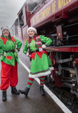 Elves dressed in a green elf costume at the Elf Express