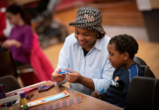A photograph of a mum and child crafting.