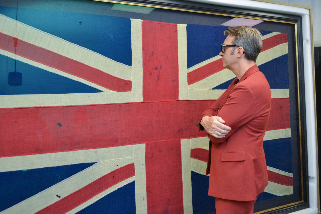 Man looking at a large Union flag. Man looking at a large Union flag.