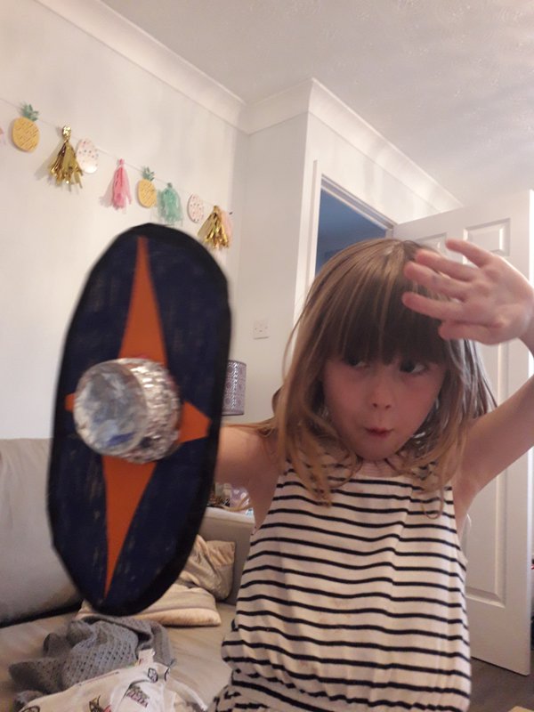 Child holding up shield