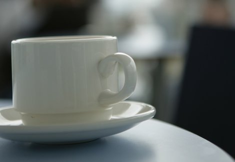 a white coffee cup with saucer