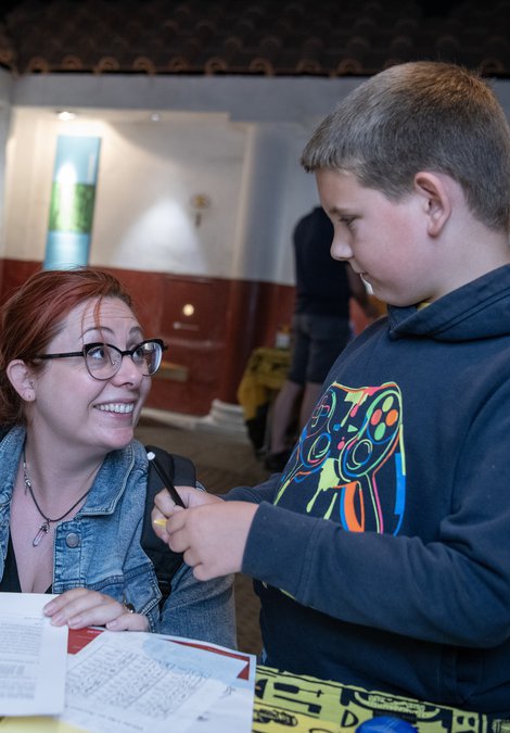 Young girl, mother, young boy doing craft activities