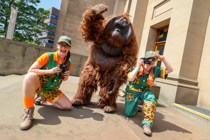 Two rangers and a Orangutan