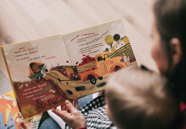 Mother reading a book to a small child