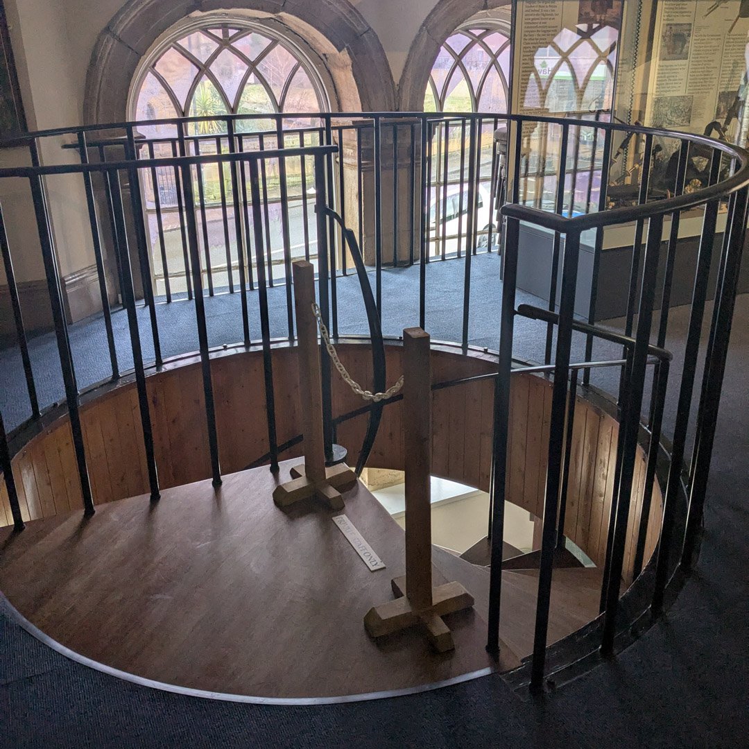 The top of a spiral staircase in a museum.
