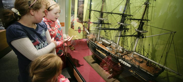 Girls looking at boat model