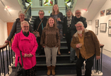 Members of the Creative Calligraphy standing on stairs in museum