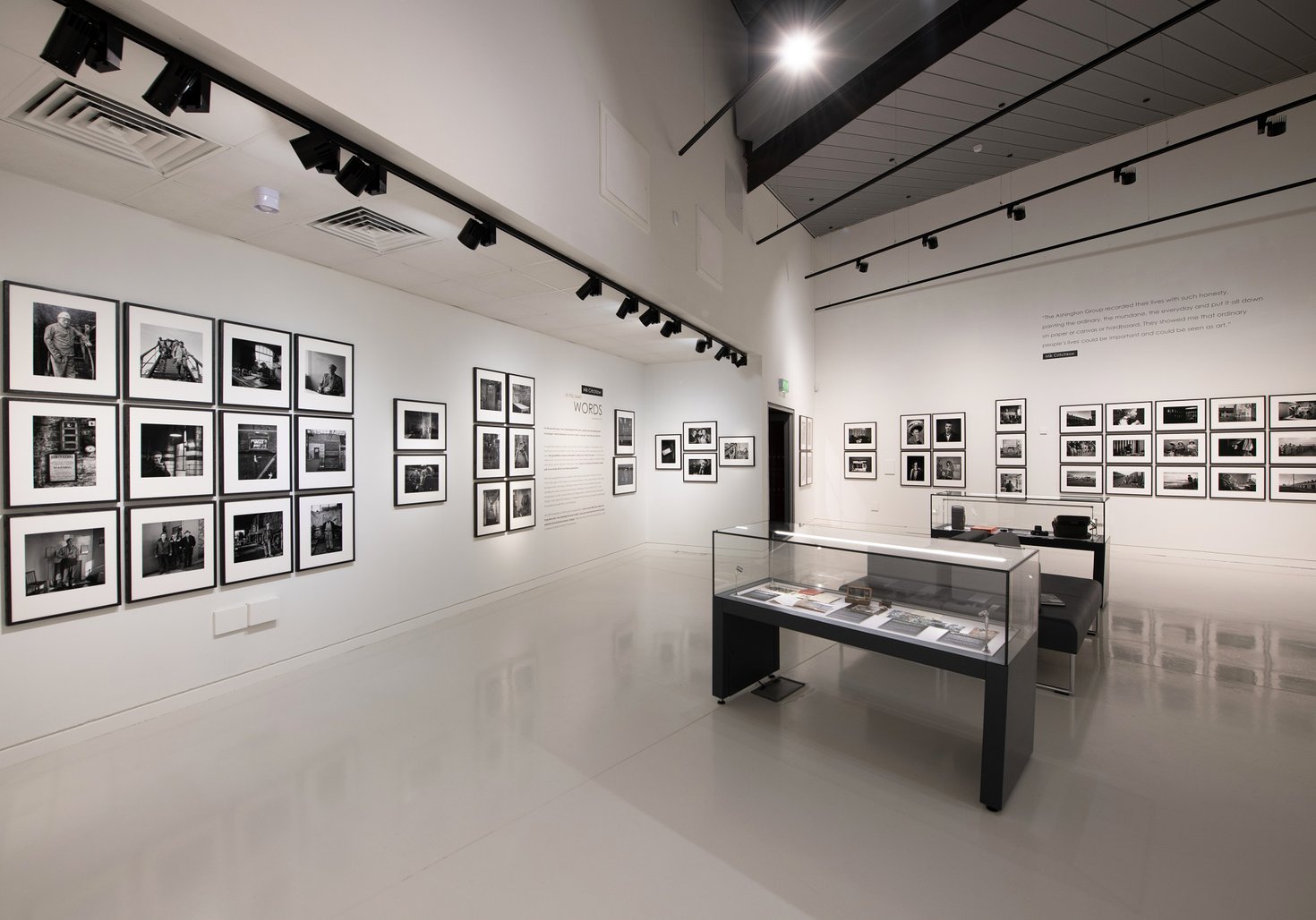 Wide view of a photgraphy exhibition in a museum.