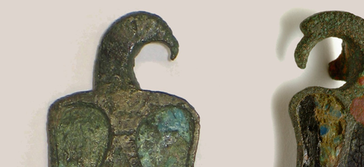 These are two examples of enamelled brooches in the shape of an eagle.