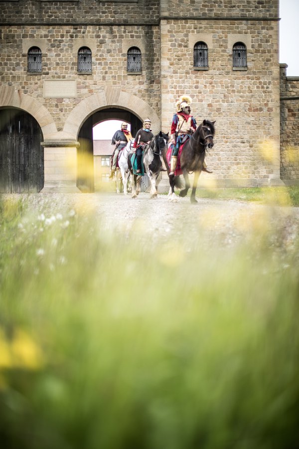 Roman soldiers on horseback leaving the fort