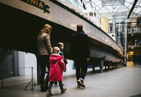 A family walks past the Turbinia exhibit