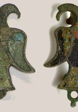 These are two examples of enamelled brooches in the shape of an eagle.