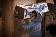 Young child at a museum interactive 