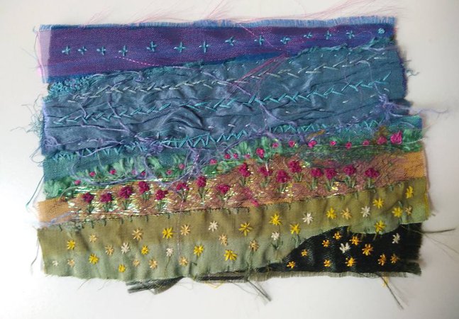 A photograph of an embroidered summer landscape.