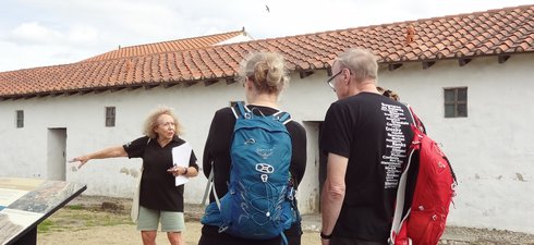 Woman giving a tour of an historic site