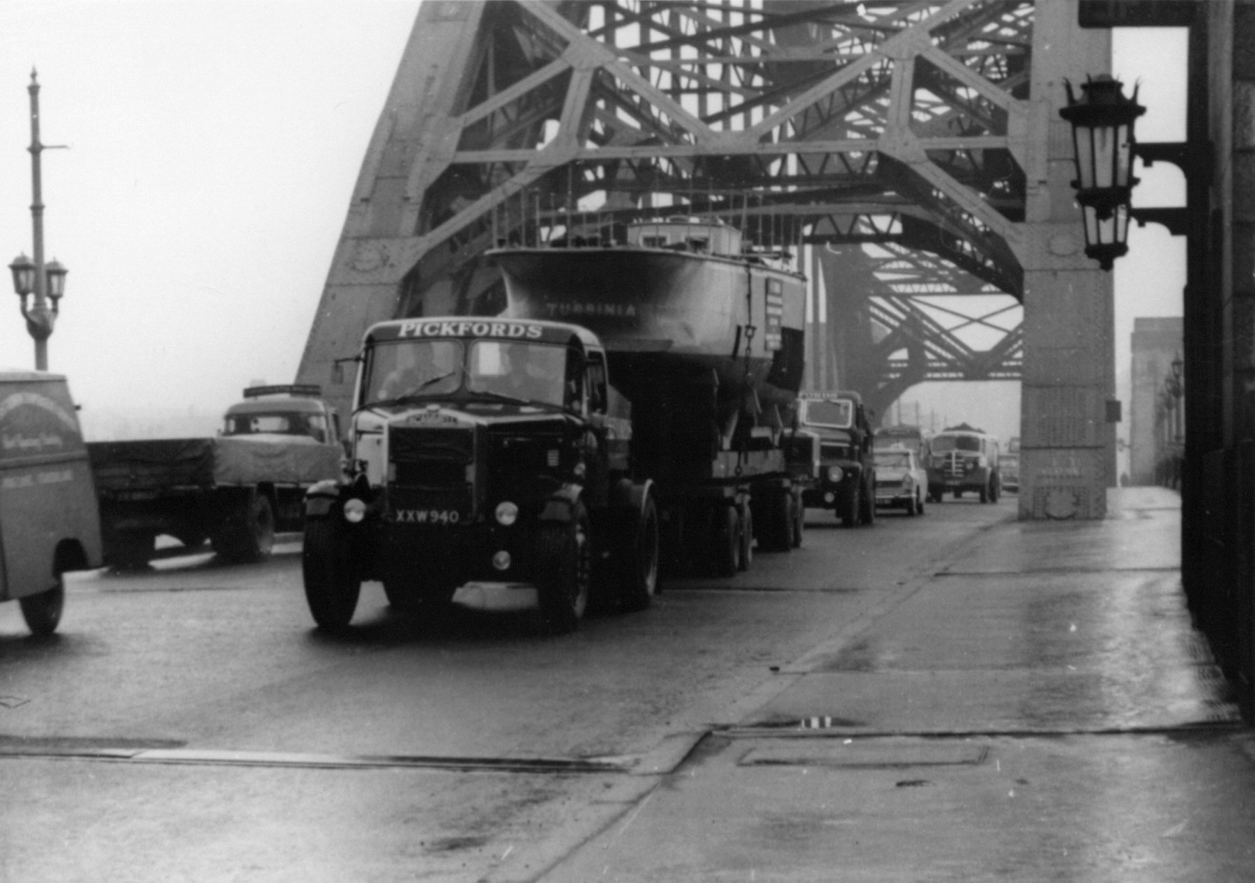 A truck carrying the stern of the ship Turbinia in traffic on the Tyne Bridge 