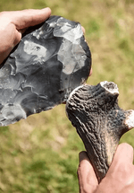 A persons hand are Flintknapping.