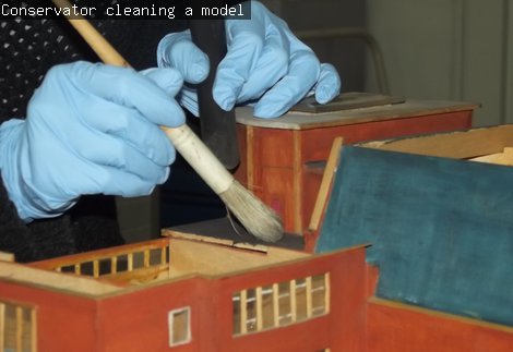 Conservator cleaning a model