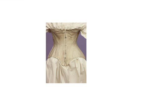 a pale pink Victorian corset on a mannequin