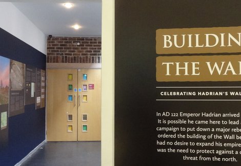 Information panels on wall by the entrance to an exhibition gallery