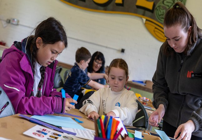 Children creating collages with materials at the Pop Up Ashington Group Hut 