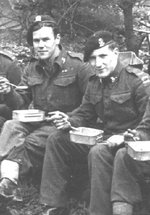 Cpl. Lucas and crew, 15th/19th Hussars, having lunch by the roadside before crossing the Rhine, March, 1945.
