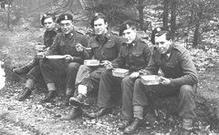 Cpl. Lucas and crew, 15th/19th Hussars, having lunch by the roadside before crossing the Rhine, March, 1945.