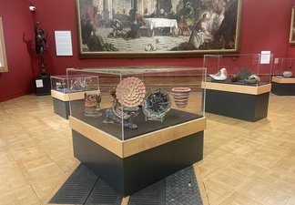 A photograph of three display cases full of ceramics 