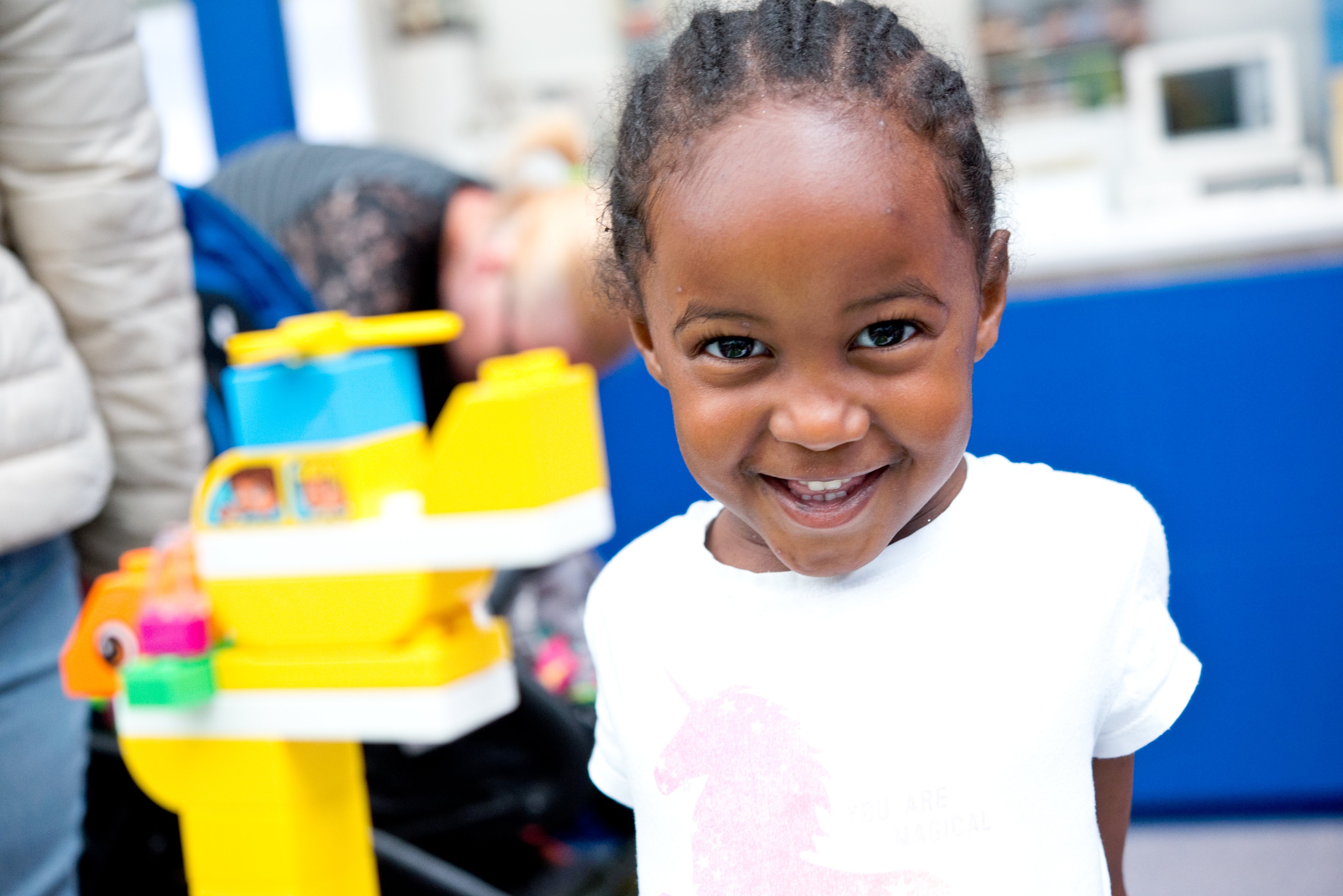 Smiling child playing with building blocks