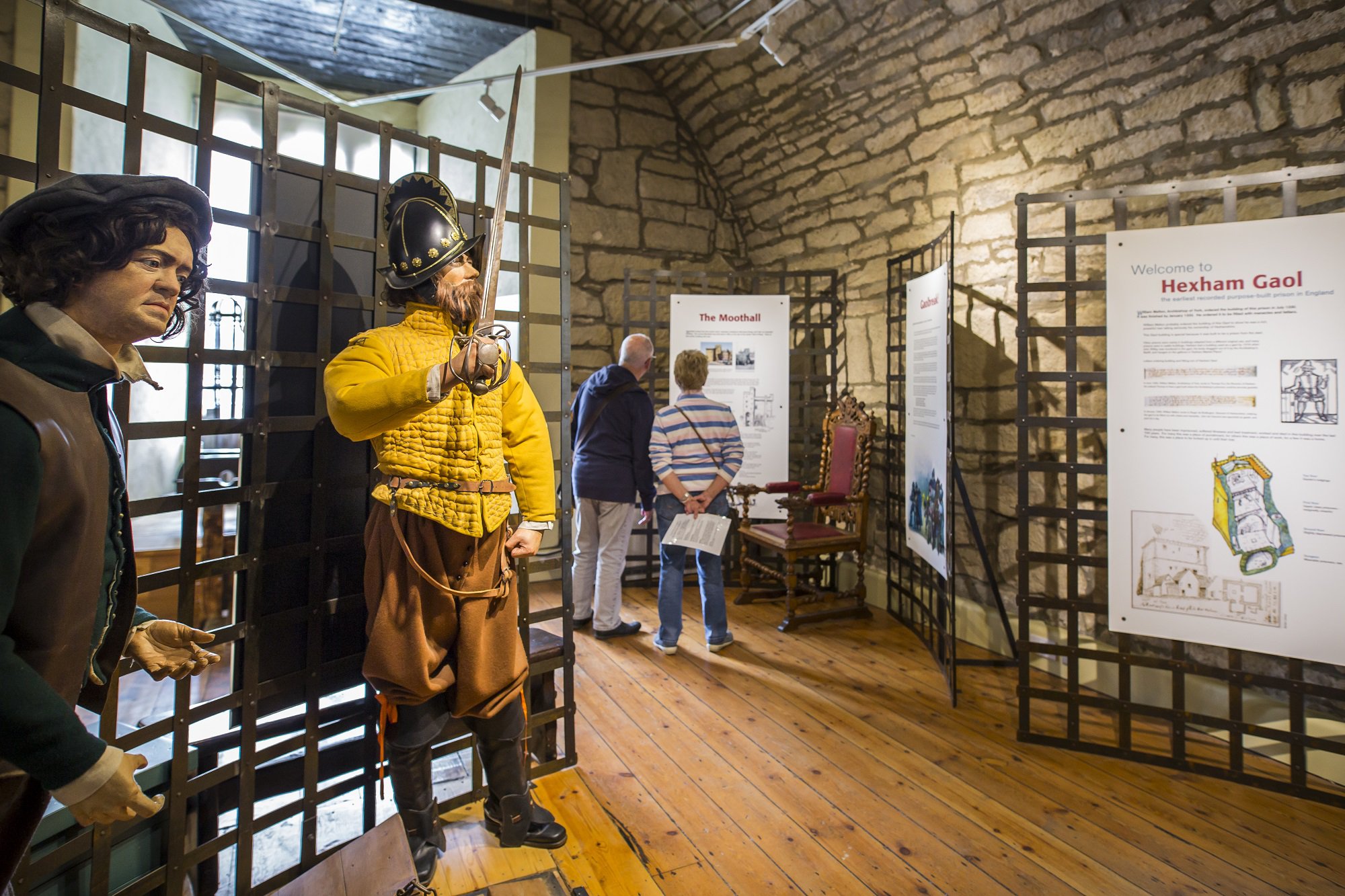 Visitors looking at interpretation boards in Hexham Old Gaol.