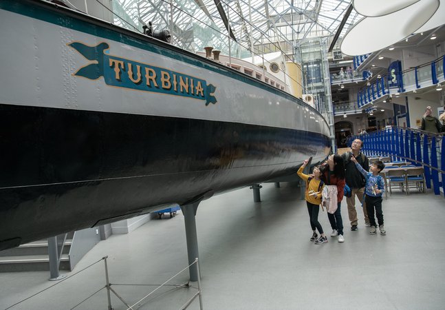 family in Discovery Museum look around