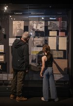 Dad and daughter look in cabinet of migration stories 