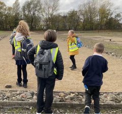 Group of school children exploring Roman fort site