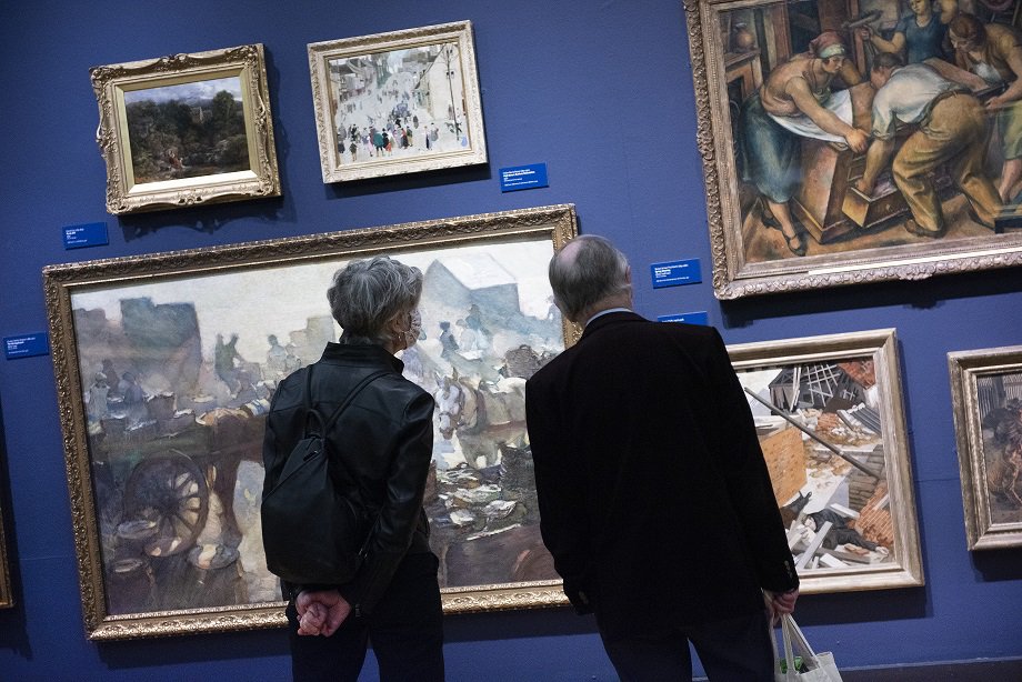 Two figures looking at paintings in the Laing Art Gallery