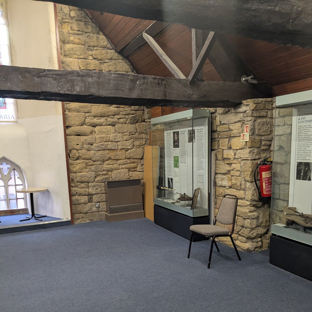 A room in a museum showing an empty chair.