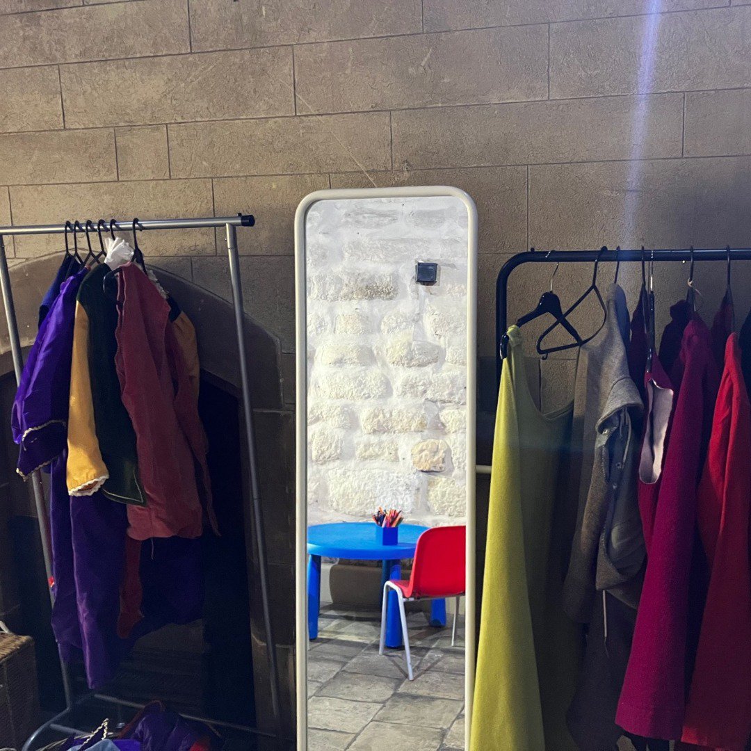 Dress up section of a museum with a mirror Dress up section of a museum with a mirror